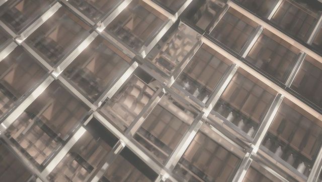 Geometric glass grid ceiling reflective mullions warm tones architectural abstraction