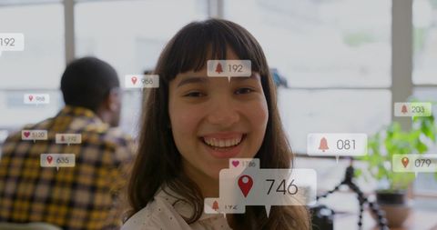 Smiling Businesswoman with Digital Notifications in Modern Office