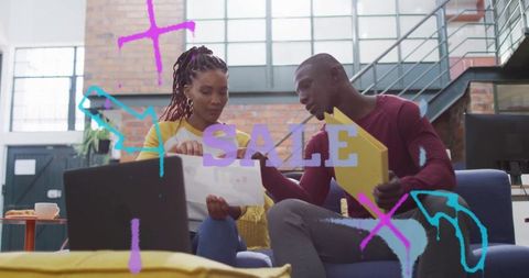 Business Team Collaborating in Industrial Space with Digital Graphics