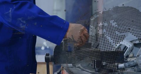 Technician clamping metal plate in bench vise in industrial workshop with perforated panel