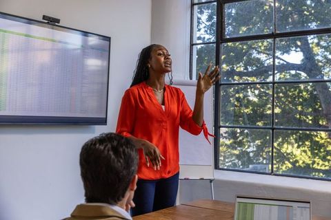 Professional Businesswoman Leading Meeting in Contemporary Office