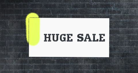 Huge Sale Announcement Spray Painted on Brick Wall with Neon Accents