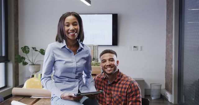 Two Young Colleagues in Modern Office Smiling at Camera - Download Free Stock Images Pikwizard.com