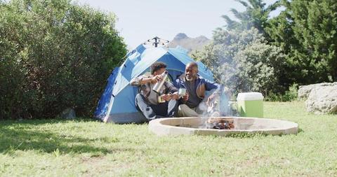 Father and Son Enjoying Coffee by Campfire at Campsite - Download Free Stock Images Pikwizard.com