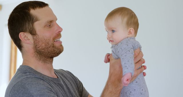 Father Holding Baby and Smiling, Bonding Moment - Download Free Stock Images Pikwizard.com