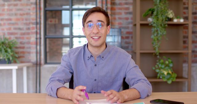 Young Professional Smiling in Trendy Office Environment - Download Free Stock Images Pikwizard.com