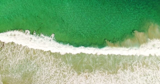 Aerial View of Waves Crashing on Green Ocean Shore - Download Free Stock Images Pikwizard.com