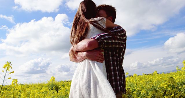 Couple Embracing in Flower Field on Sunny Day - Download Free Stock Images Pikwizard.com