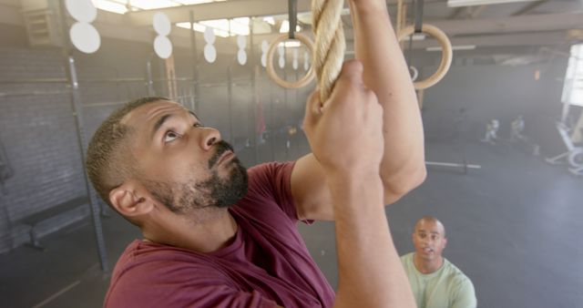 Determined Athlete Climbing Rope in Gym with Coach Encouraging - Download Free Stock Images Pikwizard.com