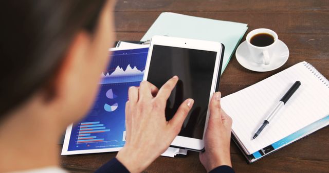 Businesswoman Analyzing Data on Tablet at Work Desk - Download Free Stock Images Pikwizard.com