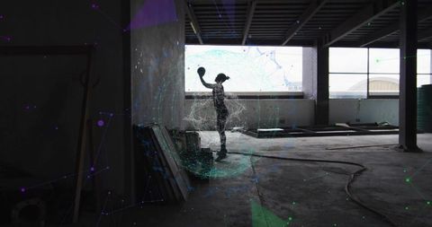 Silhouette woman holding sphere in unfinished warehouse surrounded by teal purple ar mesh