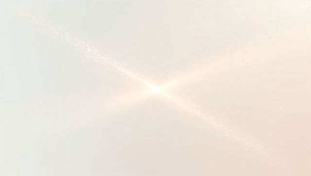 Glowing crossflare radiating sparkling diagonal beam cream ivory gradient light burst