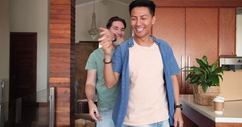 Joyful Male Couple Dancing Together at Home