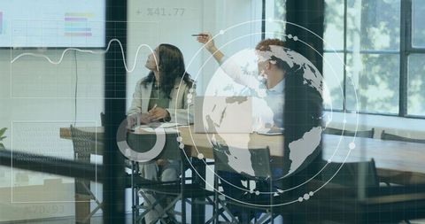 Discussing Global Data Strategy: Professionals Pointing at Display and Taking Notes