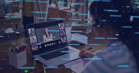 Writing teacher leading virtual classroom from home with laptop and notebook