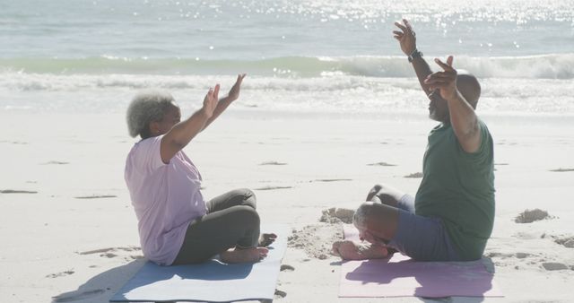 Senior couple practicing yoga by sea, morning wellness exercise on beach - Download Free Stock Images Pikwizard.com
