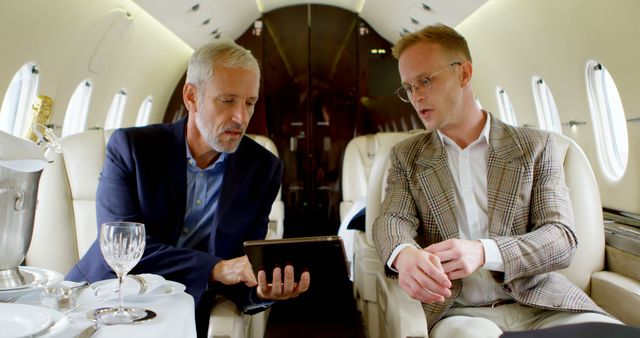 Businessmen Discussing Strategy During Private Jet Flight - Download Free Stock Images Pikwizard.com