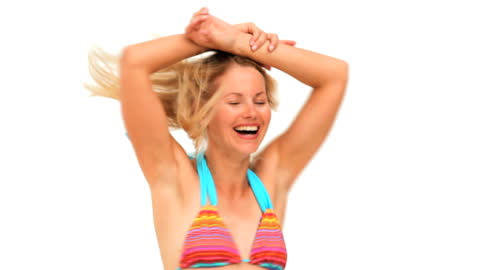 Joyful Woman Playing with Frisbee in Vibrant Bikini