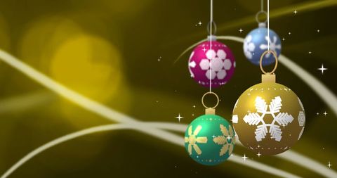 Vibrant Christmas Baubles Hanging Over Golden Bokeh Background