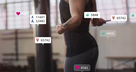 Fit woman jumping rope in gym with social media engagement overlays for fitness influencer