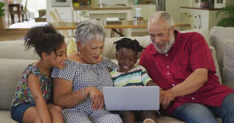 Joyful Family Bonding on Sofa with Laptop at Home