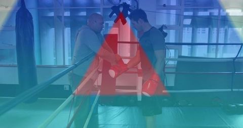 Boxing coach handing red gloves to trainee in ring coaching focused training session