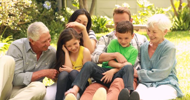 Happy Multi-Generational Family Sitting on Grass in Backyard - Download Free Stock Images Pikwizard.com