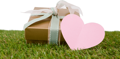 Transparent Gift Box on Grass with Heart Tag