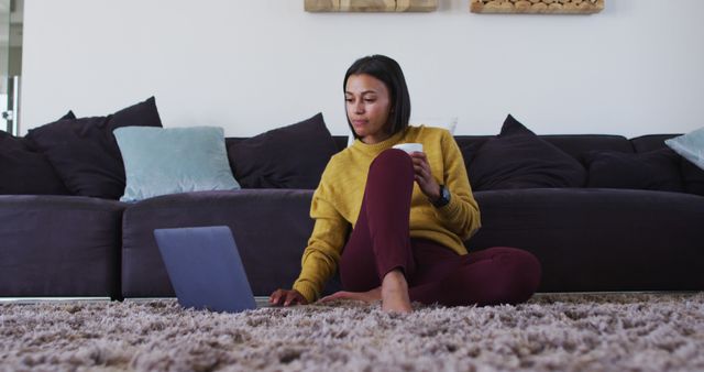 Young Woman Working From Home on Laptop While Holding Mug - Download Free Stock Images Pikwizard.com