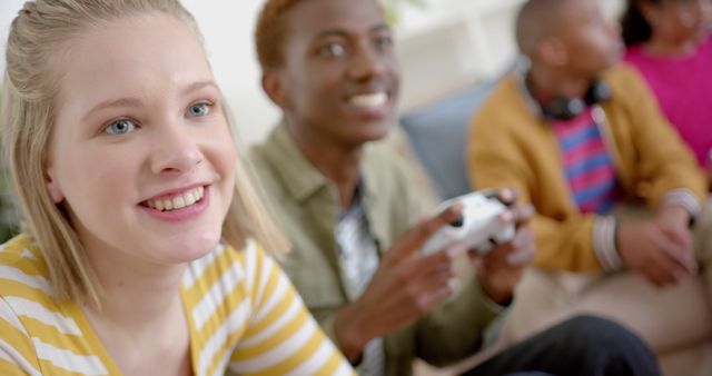 Happy Teens Playing Video Games Together on Couch - Download Free Stock Images Pikwizard.com