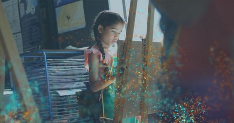 Young Girl Painting in Classroom with Light Overlay