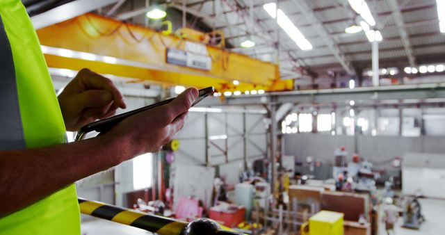 Worker Monitoring Production with Tablet in Manufacturing Facility - Download Free Stock Images Pikwizard.com