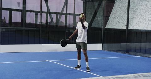 Athlete preparing to serve in padel tennis indoors