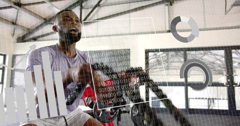 Athlete Pedaling on Stationary Bike in Gym with Augmented Reality HUD Showing Metrics
