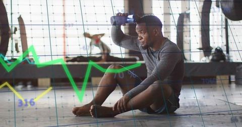 Cooling down, hydrating, tracking fitness metrics with data overlay after intense workout