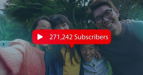 Smiling family celebrating 271,242 subscribers while taking outdoor selfie in green park