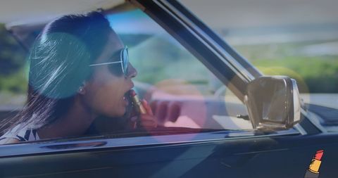Stylish Woman Applying Lipstick in Convertible - Download Free Stock Images Pikwizard.com