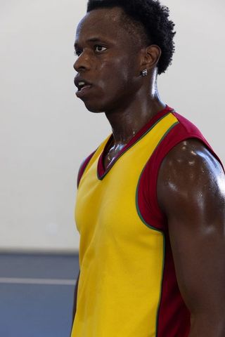 Determined Athlete Resting After Intense Workout on Basketball Court