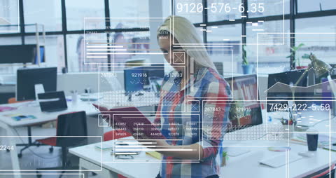 Businesswoman Analyzing Data in Modern Office With Digital Interfaces