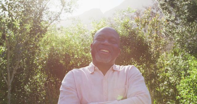 Happy Man Smiling in Sunlit Garden on Sunny Day - Download Free Stock Images Pikwizard.com