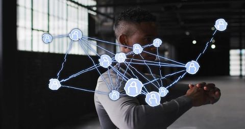 Man in industrial loft in fitted top with holographic network visualization for connectivity