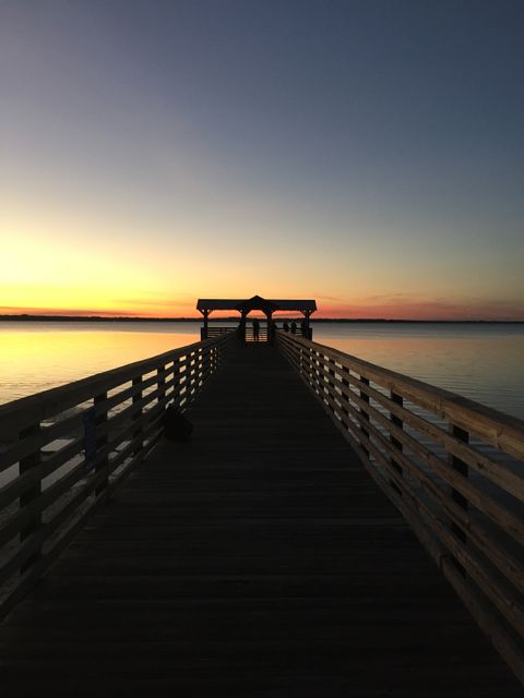 Serene Sunset at a Wooden Dock over Calm Water - Download Free Stock Photos Pikwizard.com