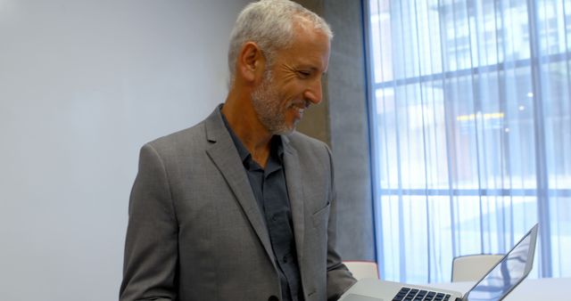 Senior Businessman Thinking While Working on Laptop in Modern Office - Download Free Stock Images Pikwizard.com