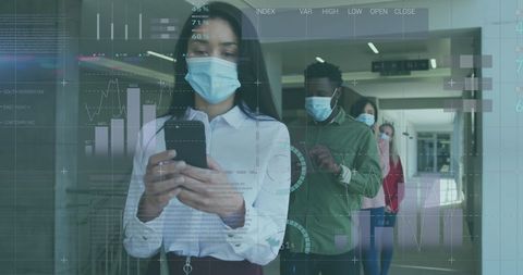 Business colleagues in masks analyzing digital statistics at workplace