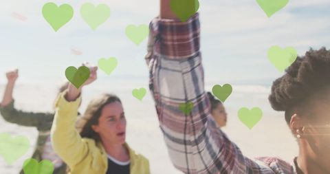 Diverse Group Raising Fists with Green Heart Overlays in Solidarity