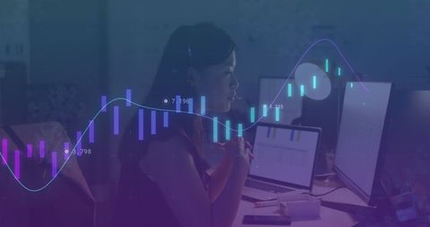 Businesswoman analyzing data with advanced graphs and charts in office