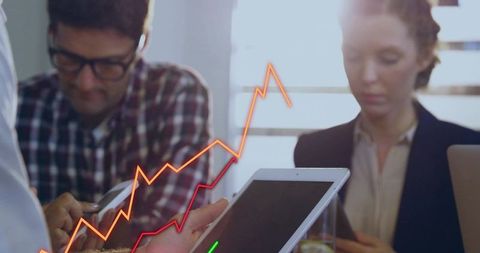 Professionals Analyzing Rising Financial Trends on Tablet During Team Meeting