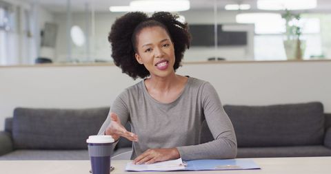 African American Businesswoman Engaged in Video Call at Modern Office