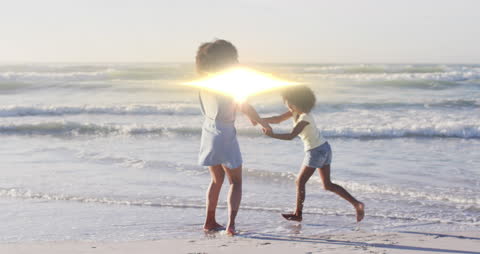 Joyful Mother and Daughter Dancing on Beach with Light Effects