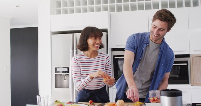 Image of diverse couple preparing fruits for juice - Download Free Stock Photos Pikwizard.com